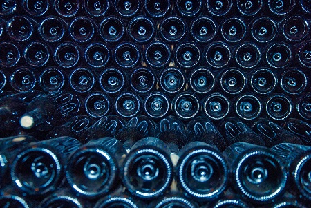 Rows of wine bottle stored on their side viewed from the bottom