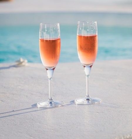 Two glasses of Renegade and Longton blush elderflower and rhubarb sparkling wine at the beach