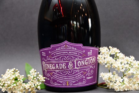 Bottle of Renegade and Longton elderflower sparkling wine with fresh elderflowers